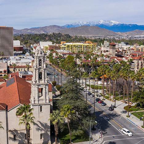 Inland Empire cityscape with palm-lined streets and mountains